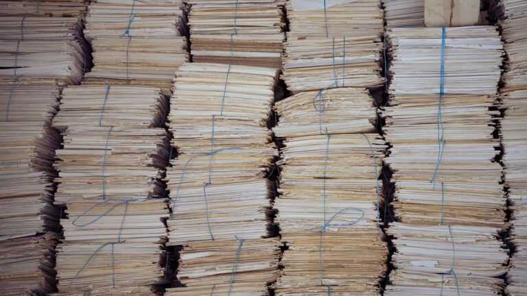 High stacks of organized, bound paper bundles create a structured and neat appearance.