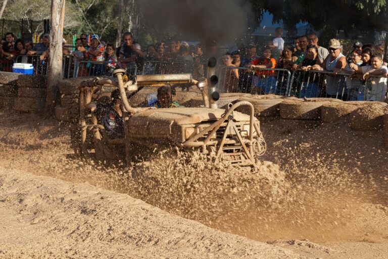 Exciting off-road vehicle splashes through mud, captivating spectators in Rio de Janeiro.